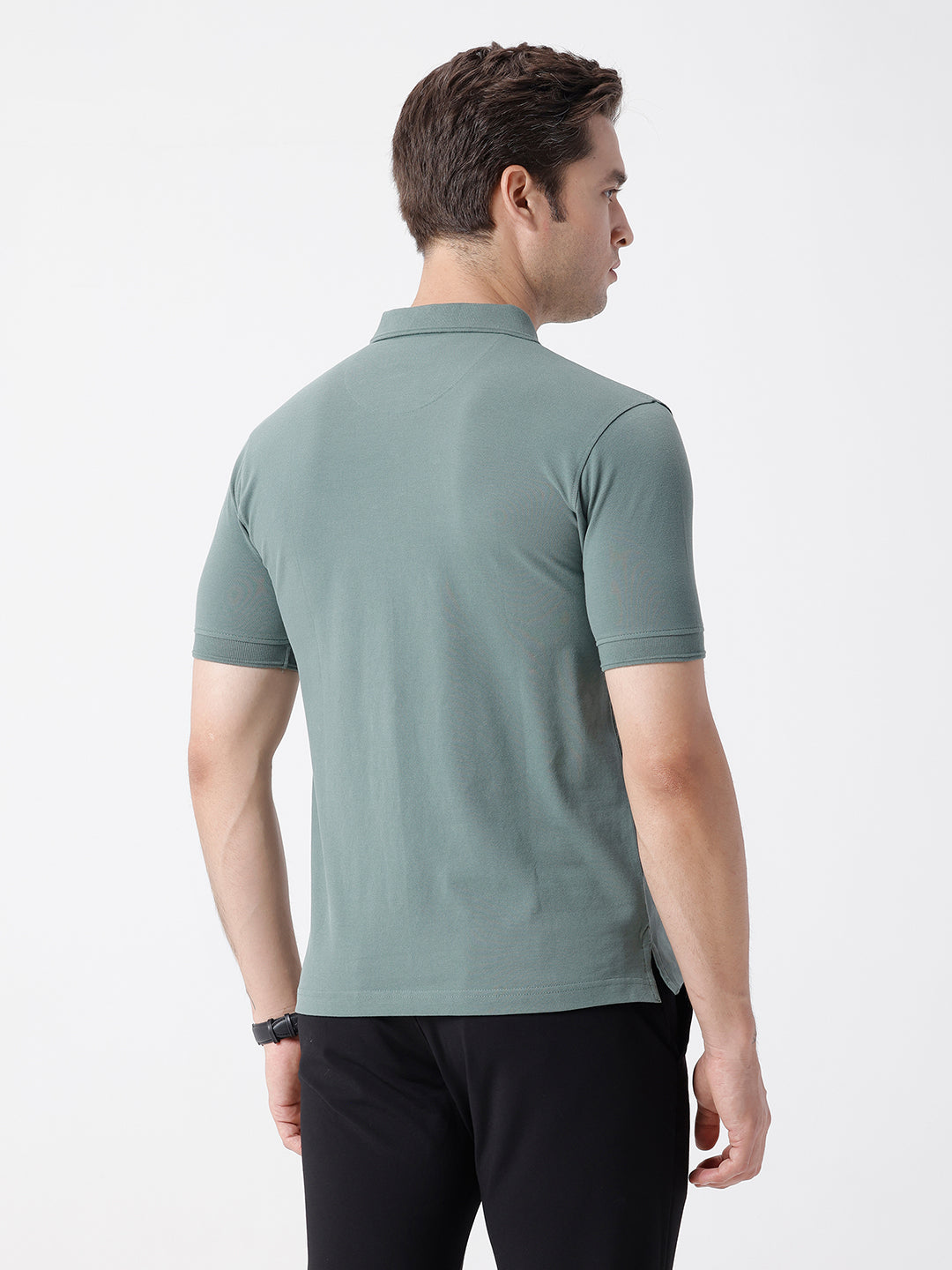 Man wearing a green iceberg green chest print slim fit polo t shirt on a light gray background