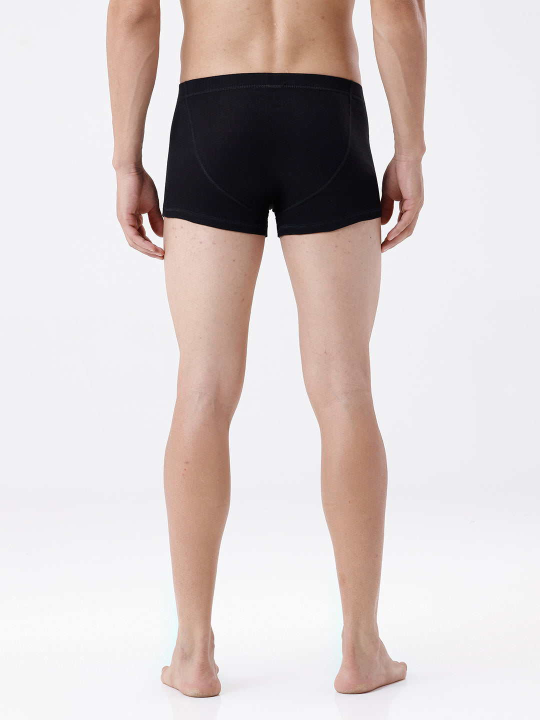 Person wearing black boxer briefs on a white background