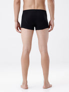 Person wearing black boxer briefs on a white background