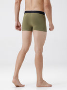Person wearing olive green boxer briefs on a white background