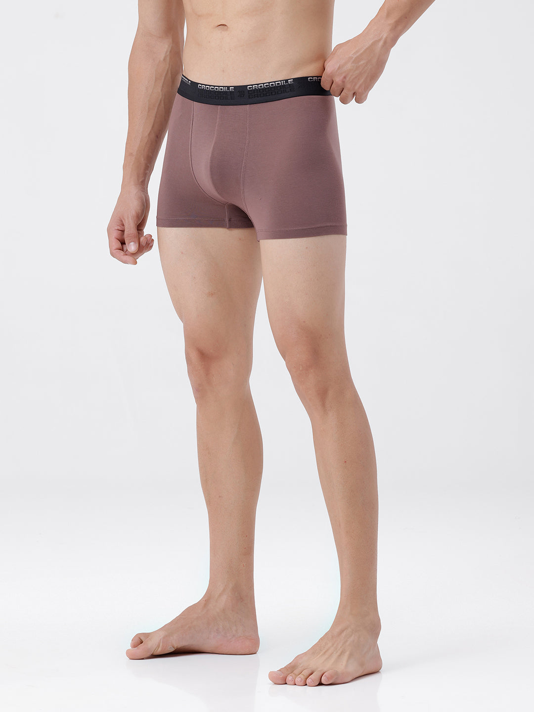 Man wearing brown boxer briefs on a white background