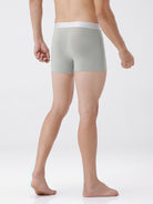 Person wearing light gray boxer briefs on a white background