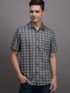 Man wearing a grey grey checked half sleeve shirt on a light gray background