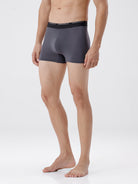 Person wearing gray boxer briefs on a white background