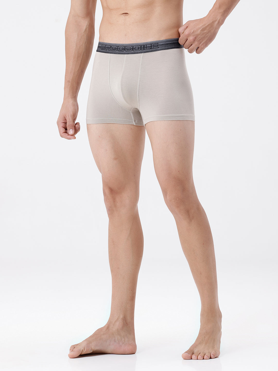 Man wearing beige boxer briefs on a white background