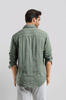 Man wearing a green textured shirt against a white background