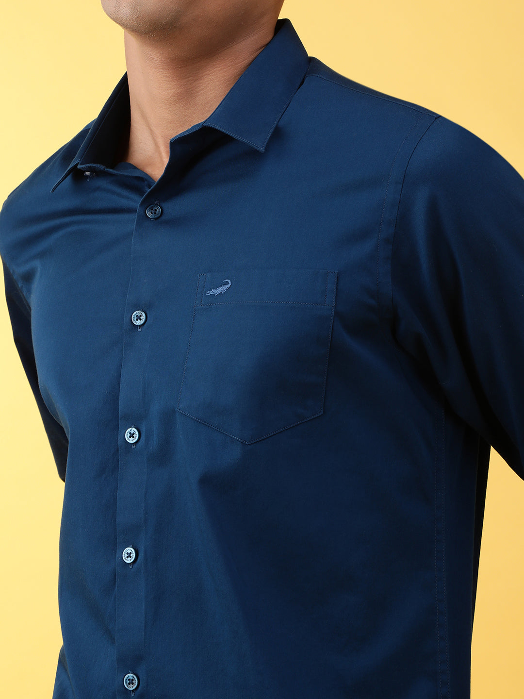Man wearing a blue royal blue solid full sleeve 100% cotton casual shirt with casual styling on a gray background
