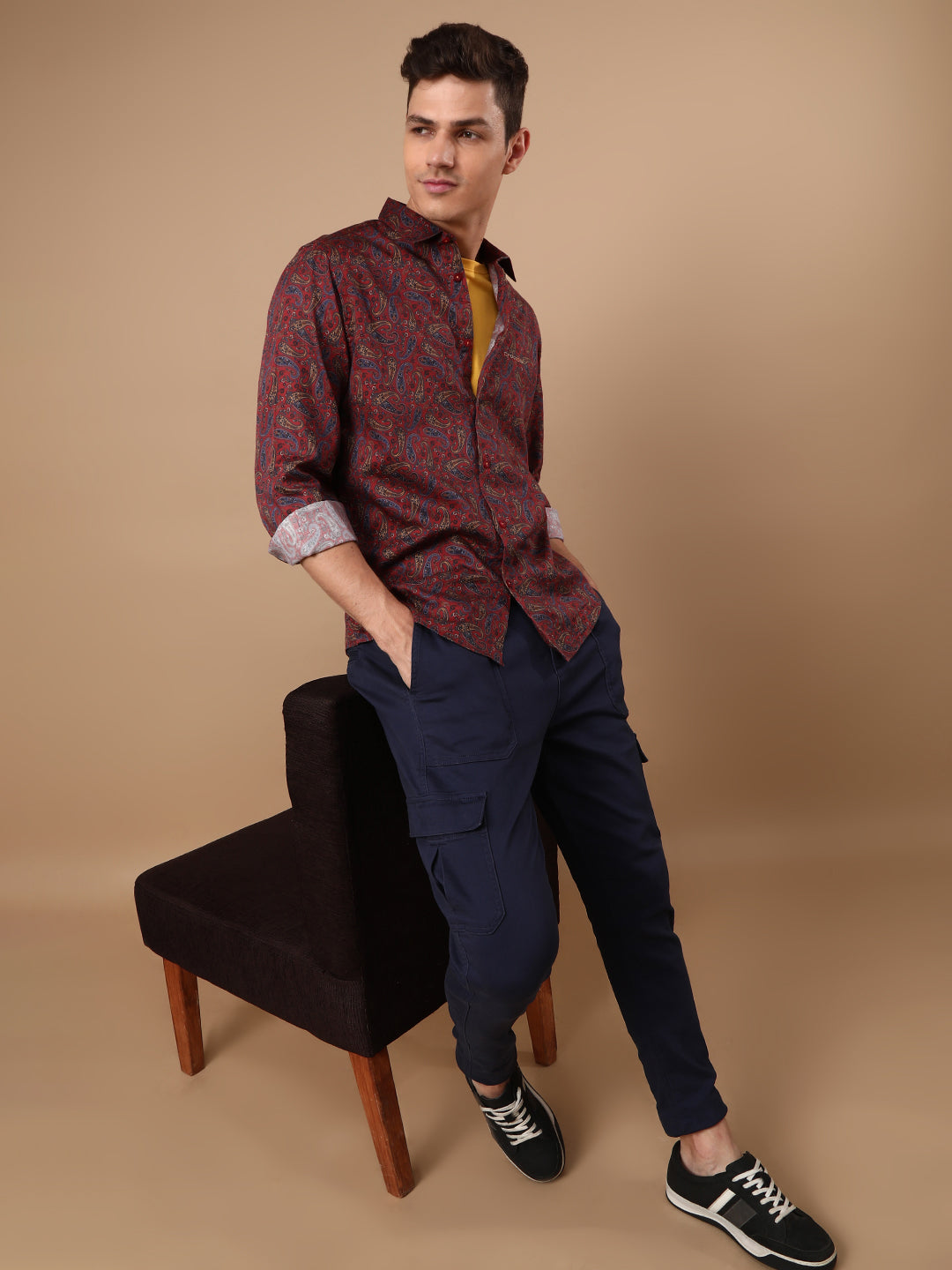 Man wearing a red red printed full sleeve 100% cotton shirt on a light gray background