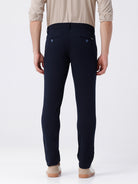 Man wearing a red textured essential chinos navy with casual styling on a gray background