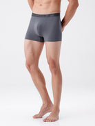Person wearing gray boxer briefs on a white background