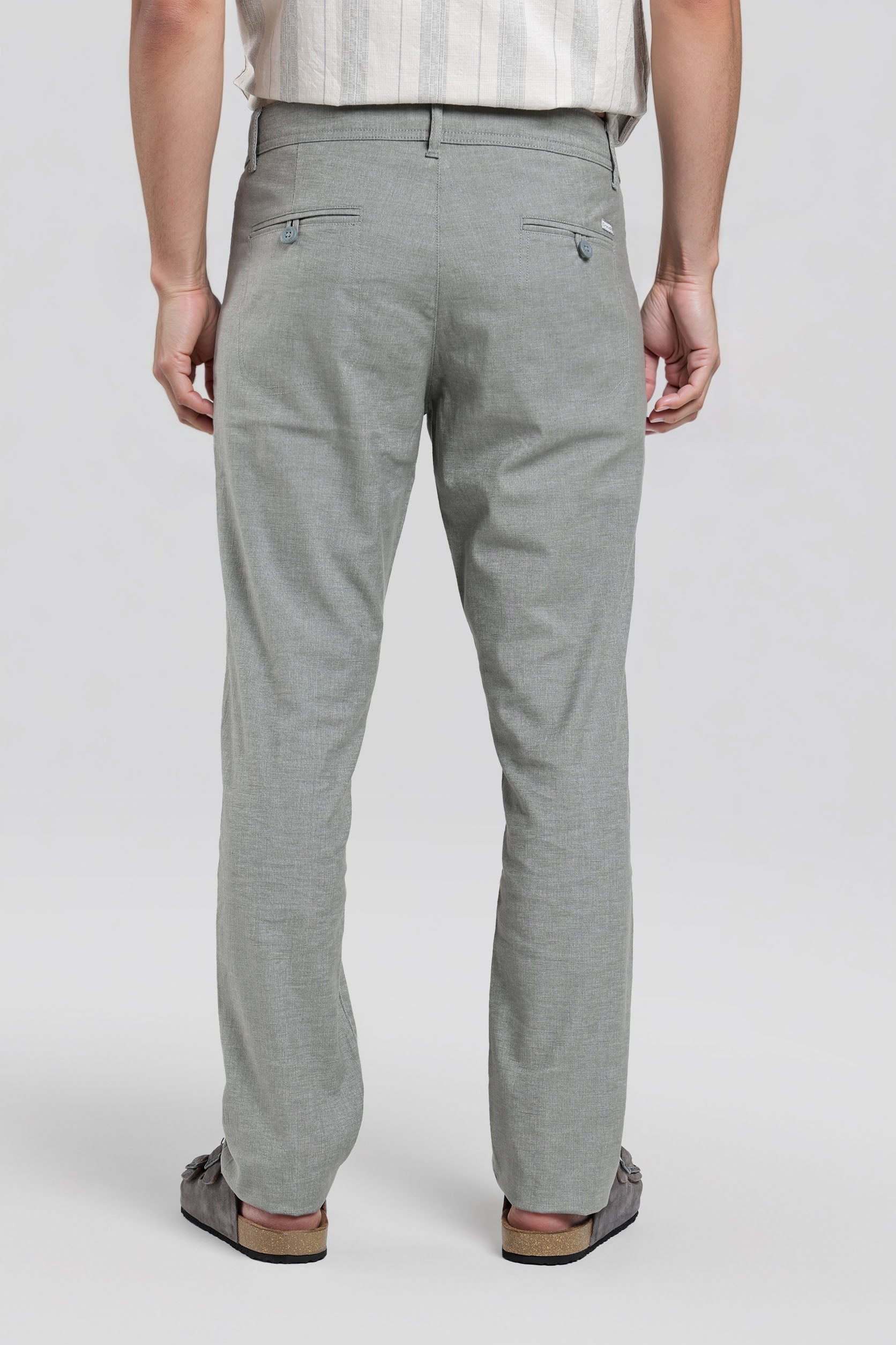 Person wearing gray pants on a white background