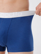 Blue boxer briefs with white waistband featuring 'coolibar' brand on a neutral background