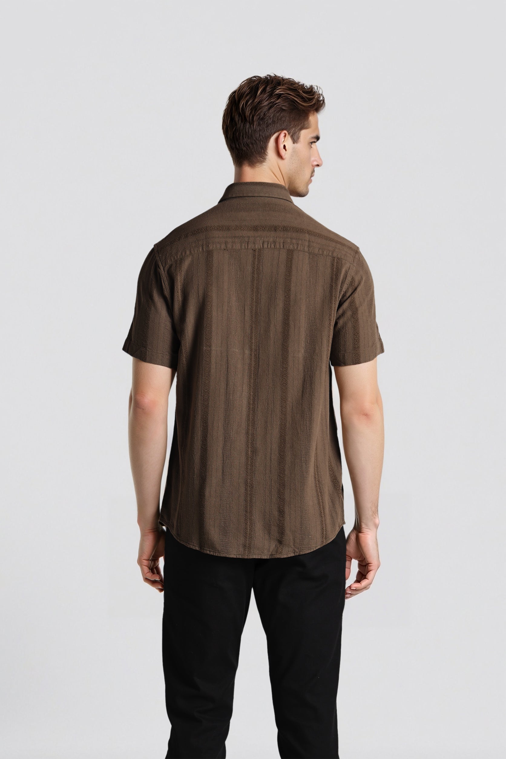 Man wearing a brown short-sleeve shirt on a white background