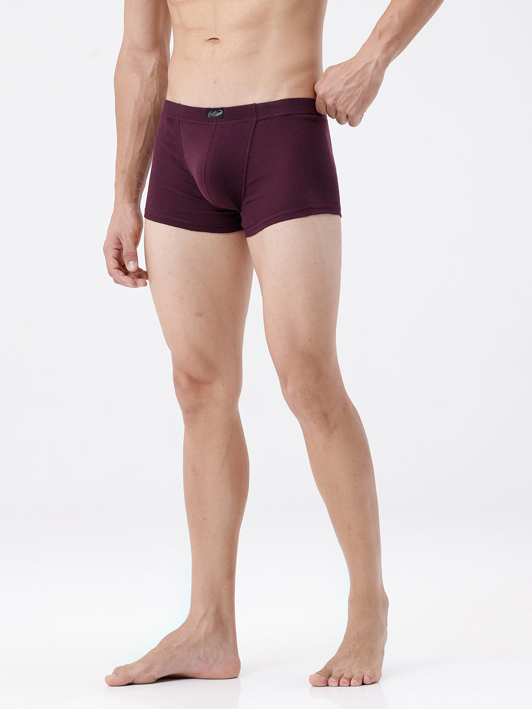 Man wearing purple underwear on a white background