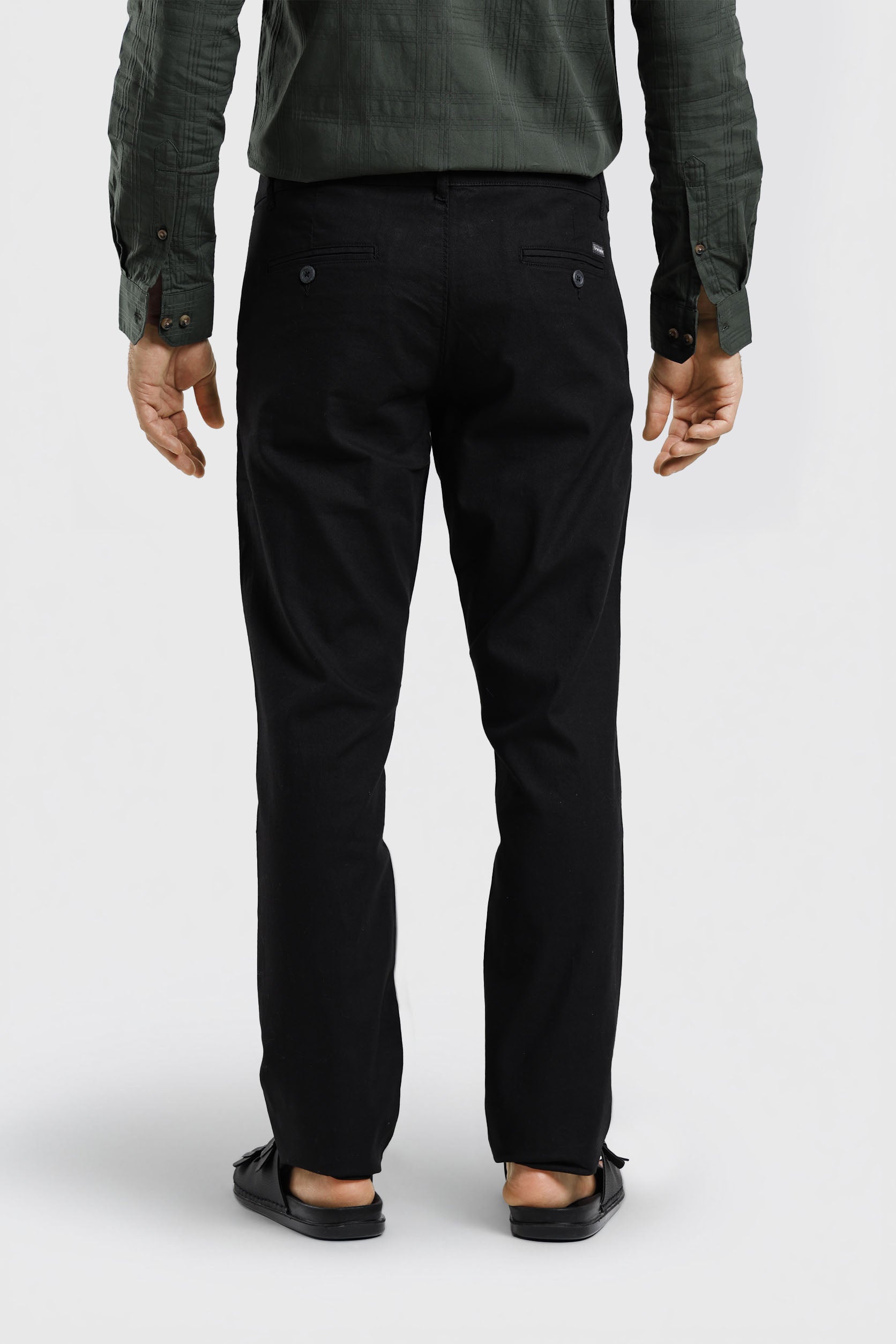 Person wearing black pants on a white background