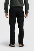 Person wearing black pants on a white background