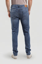 Person wearing blue jeans on a white background