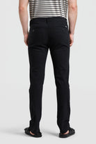 Person wearing black pants on a white background