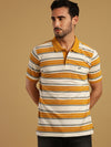 Man wearing a white golden yellow and white striped polo t shirt with casual styling on a gray background