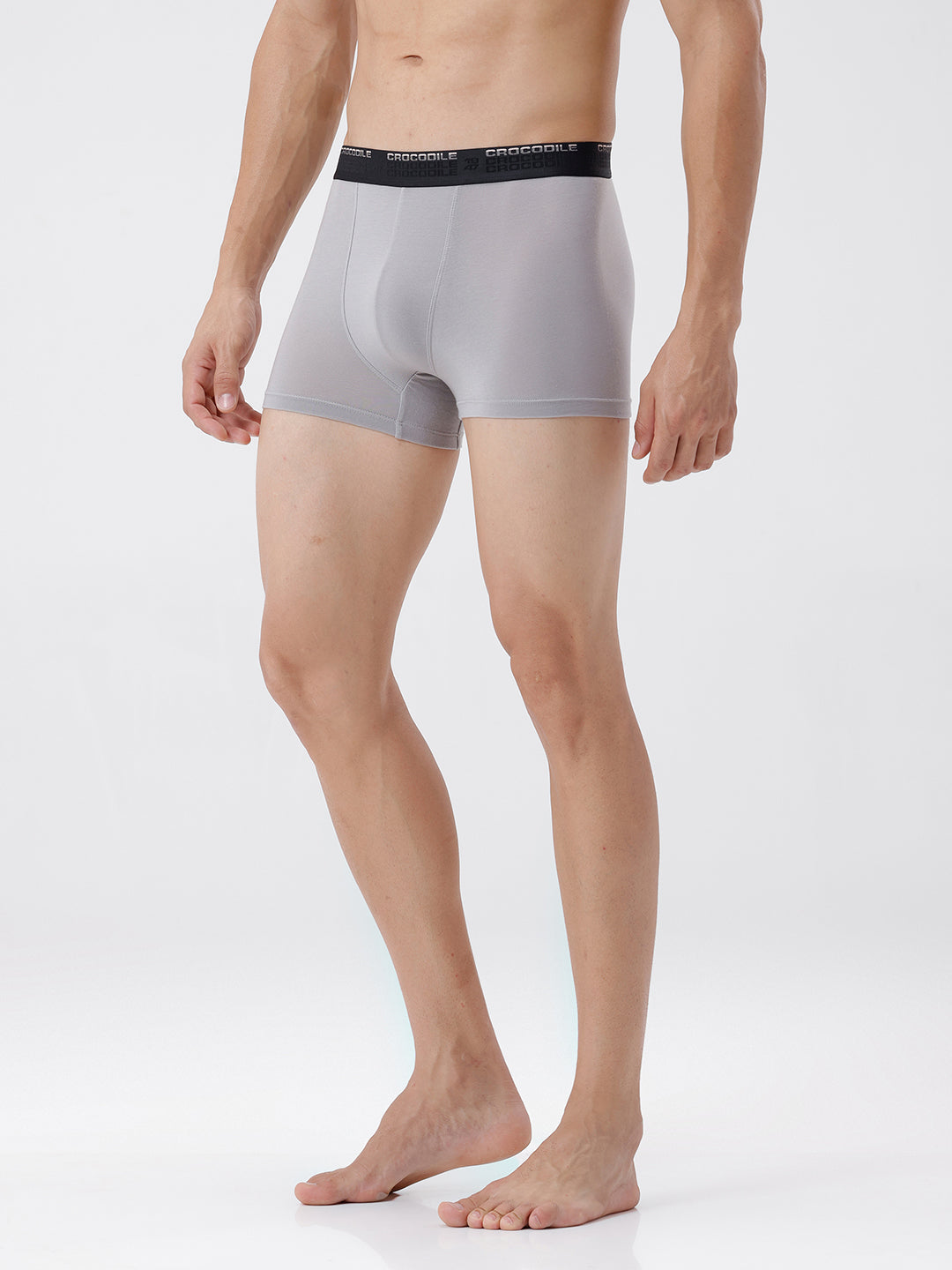 Person wearing gray boxer briefs with a black waistband on a white background