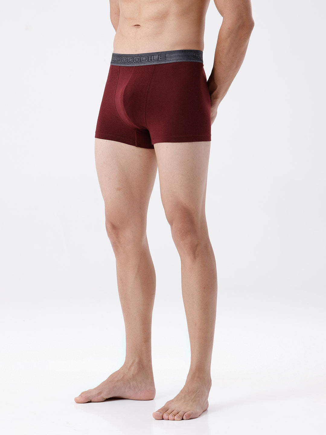 Man wearing maroon boxer briefs on a white background