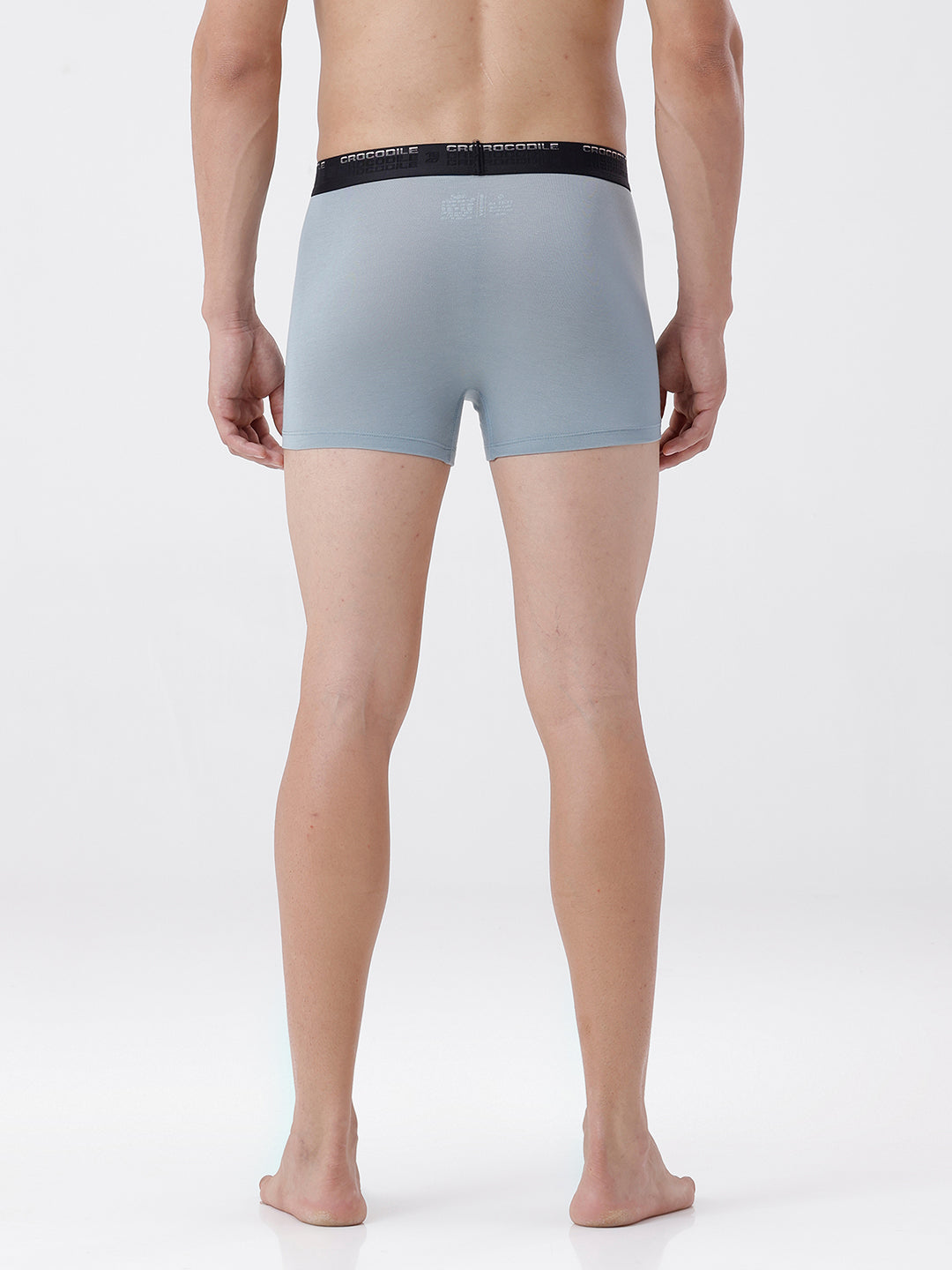 Person wearing light gray boxer briefs with a black waistband on a white background