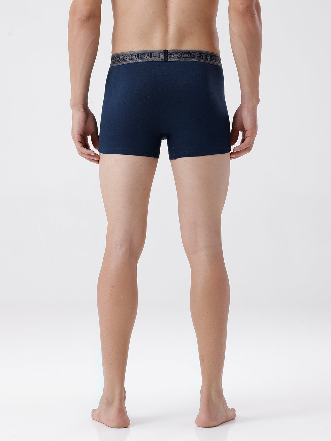 Person wearing navy blue boxer briefs on a white background