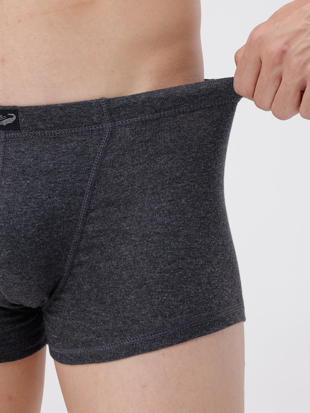 Person wearing dark gray boxer briefs on a light gray background