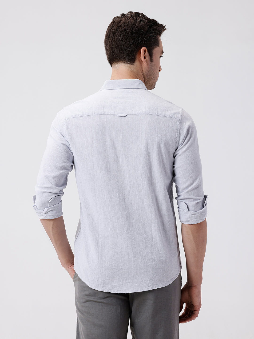 Man wearing a grey rib textured cotton shirt grey on a light gray background