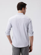 Man wearing a grey rib textured cotton shirt grey on a light gray background