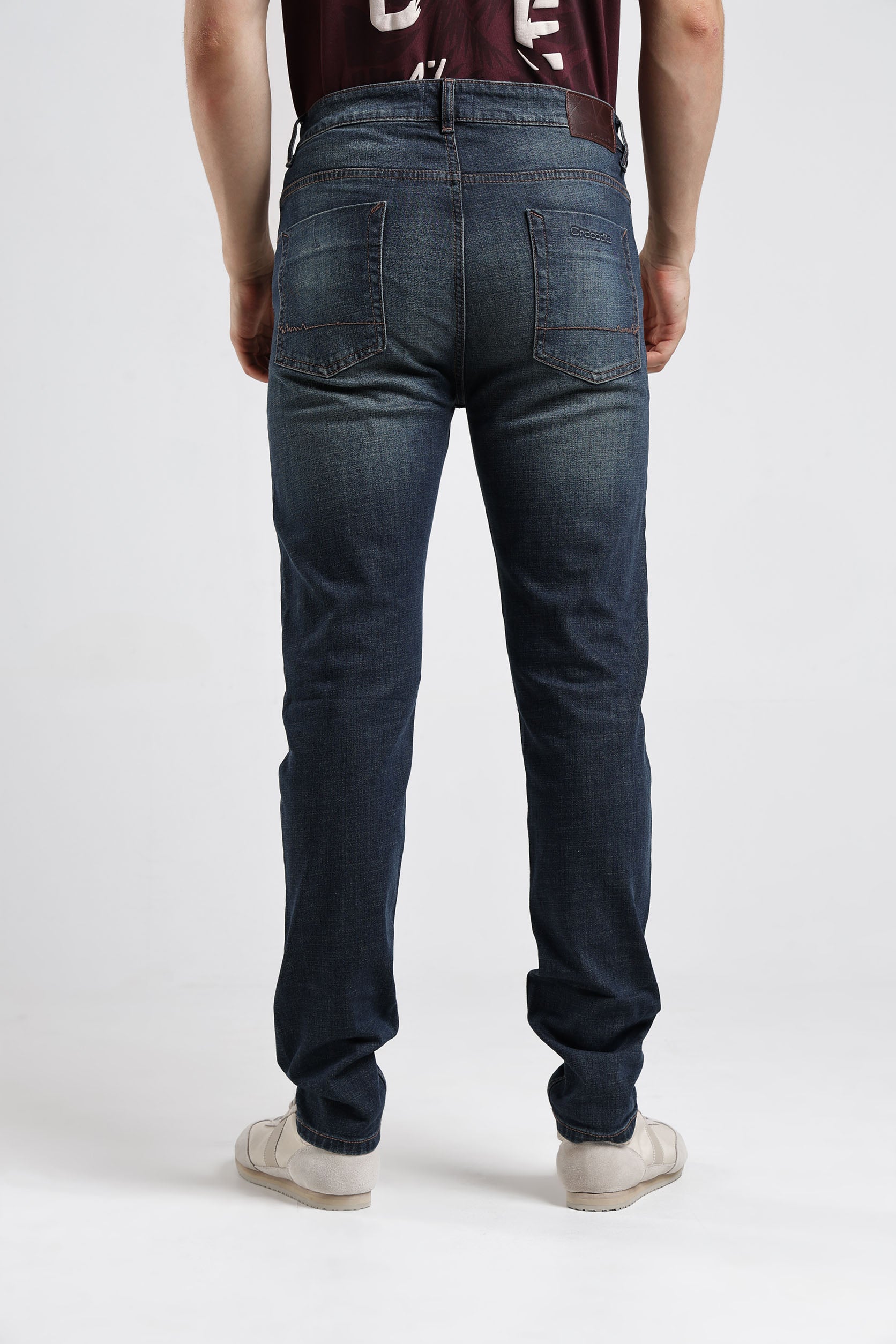 Person wearing blue jeans on a white background