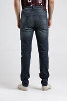 Person wearing blue jeans on a white background