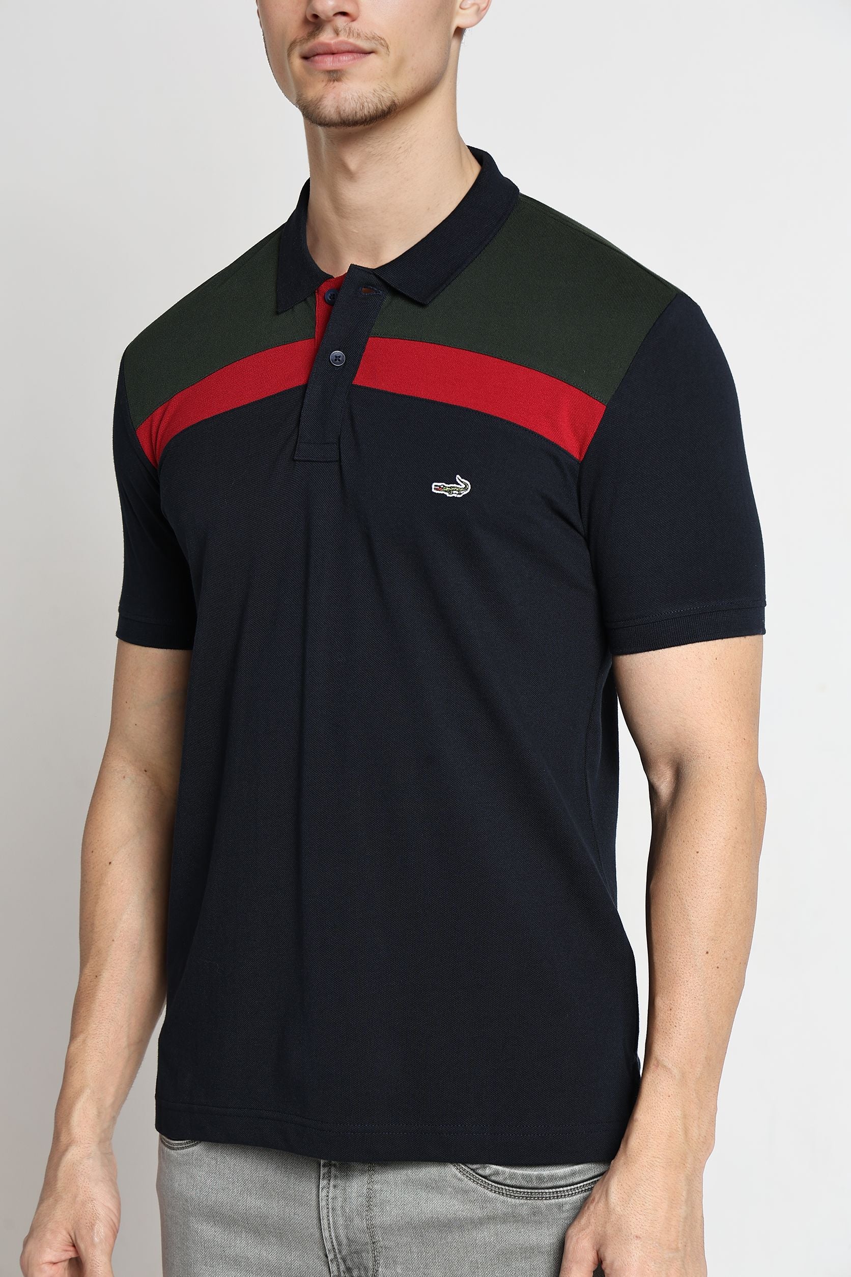 Man wearing a black and red striped polo shirt on a plain background