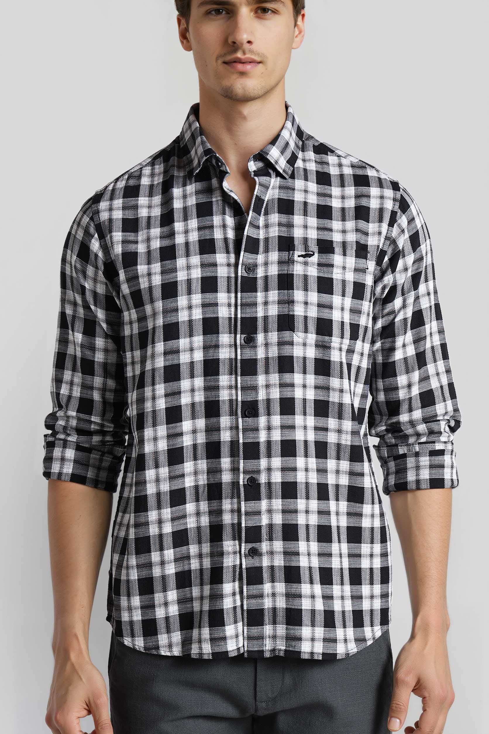 Man wearing a black and white checkered shirt on a light gray background