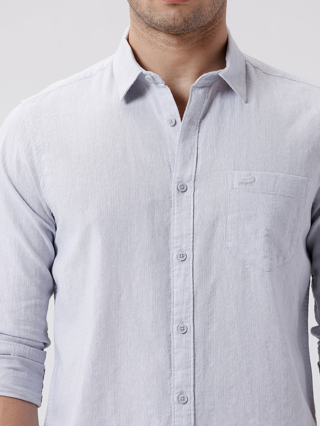 Man wearing a grey rib textured cotton shirt grey on a light gray background