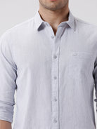 Man wearing a grey rib textured cotton shirt grey on a light gray background