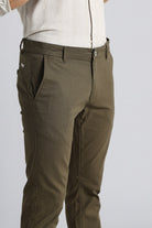 Brown pants worn by a person on a light gray background