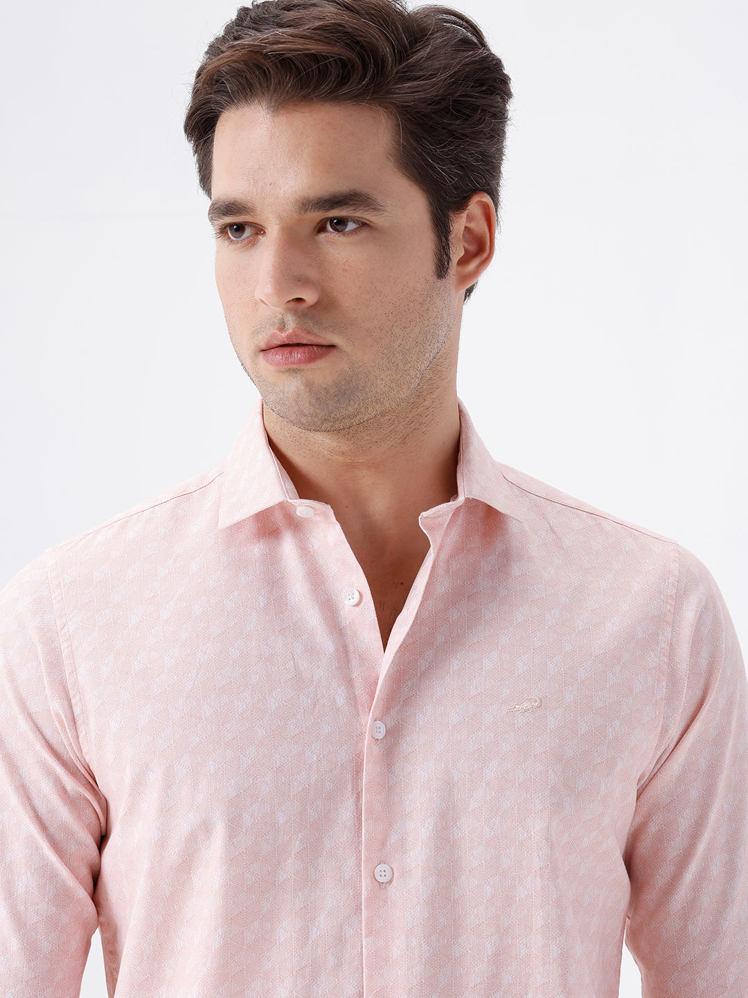 Man wearing a geomentic diamond print shirt orange on a light gray background