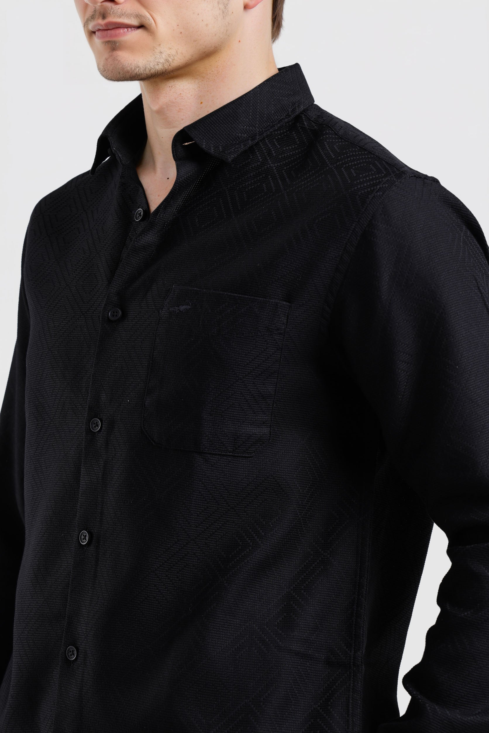 Black shirt worn by a person on a white background