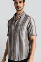 Man wearing a striped shirt with a plain background