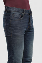Blue jeans worn by a person on a white background