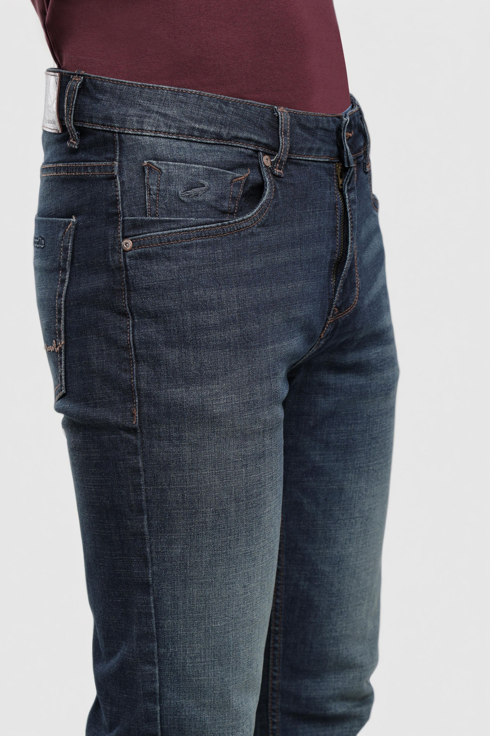 Blue jeans worn by a person on a white background