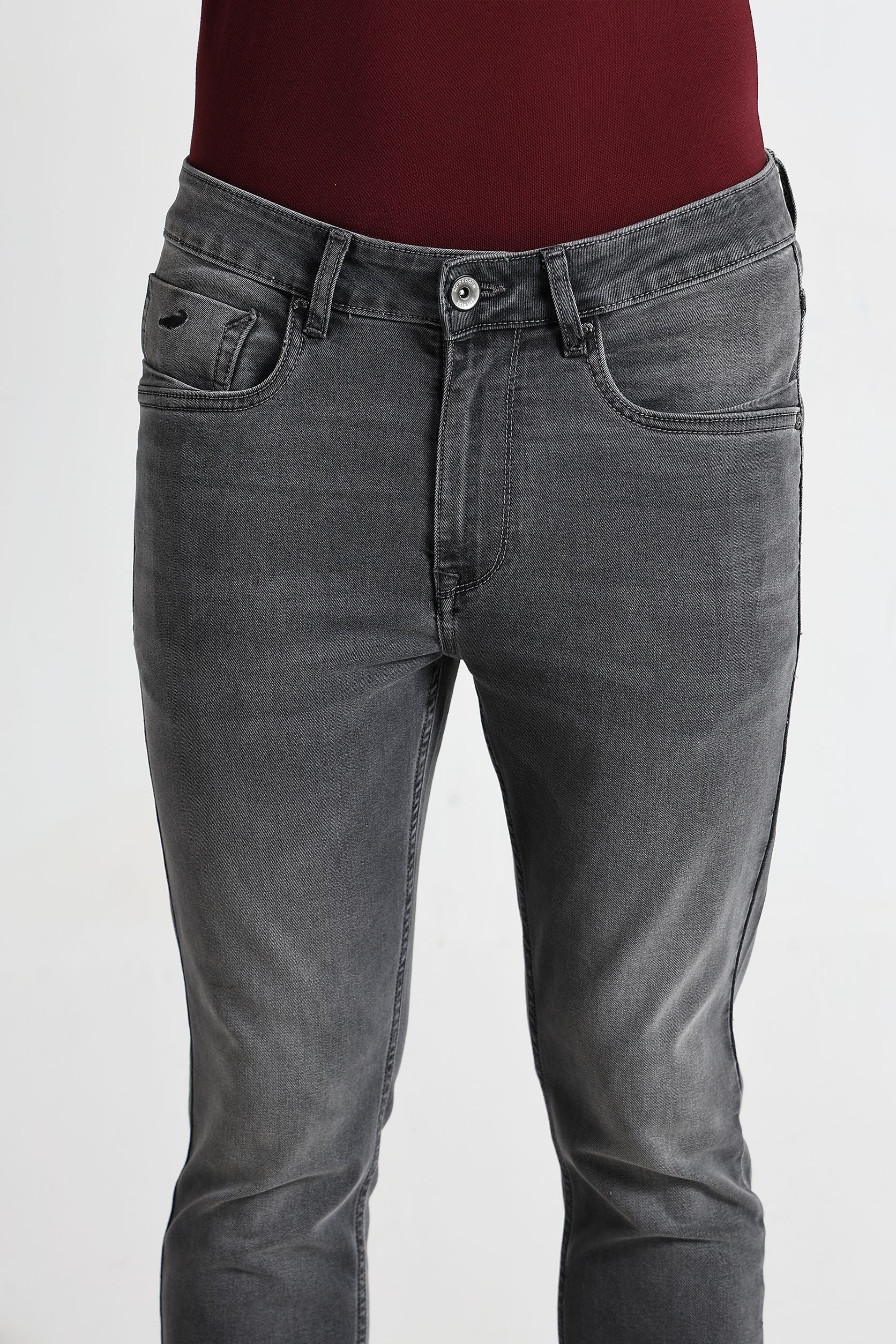 Gray jeans worn by a person on a white background