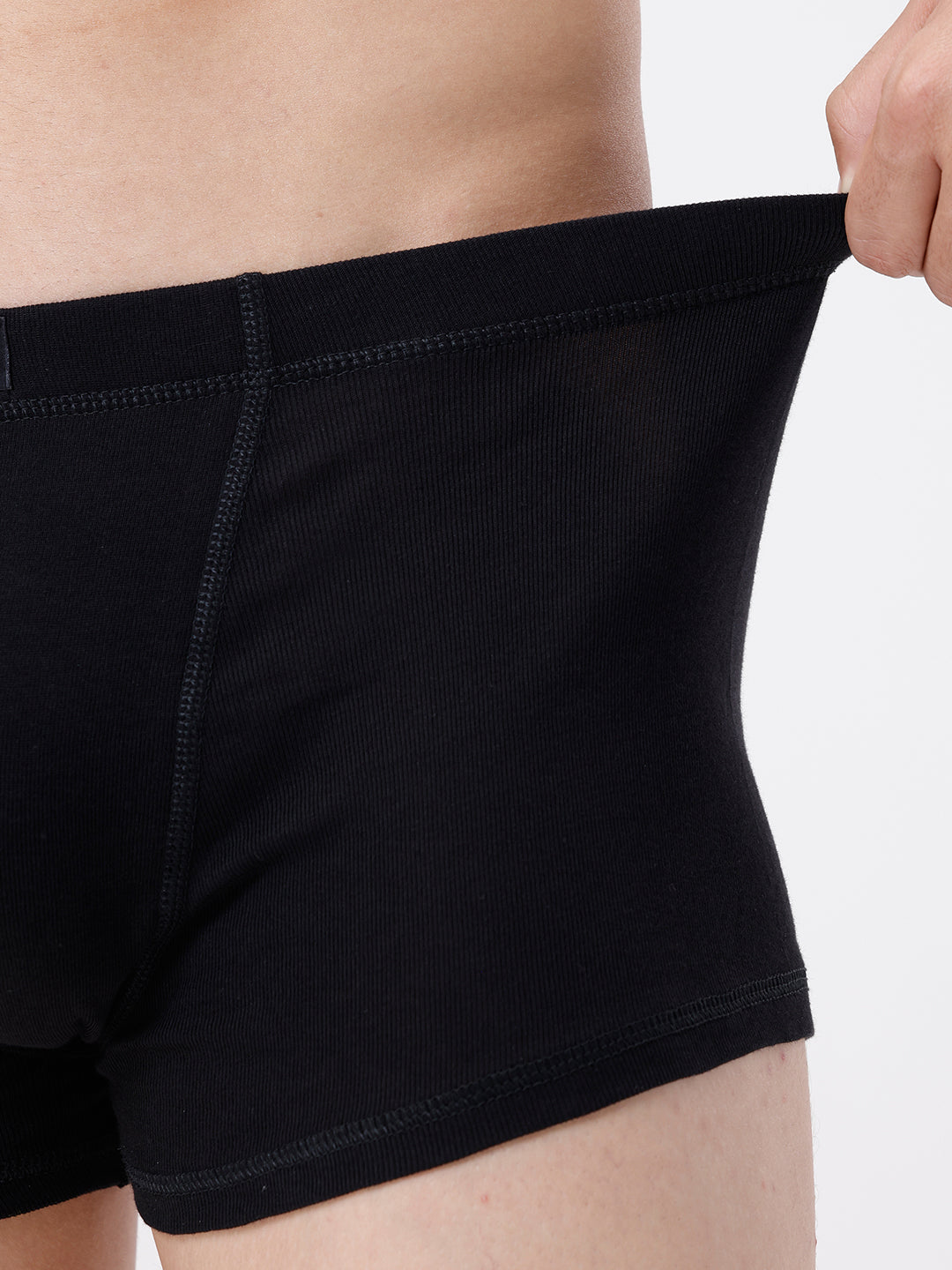 Person wearing black boxer briefs on a plain background