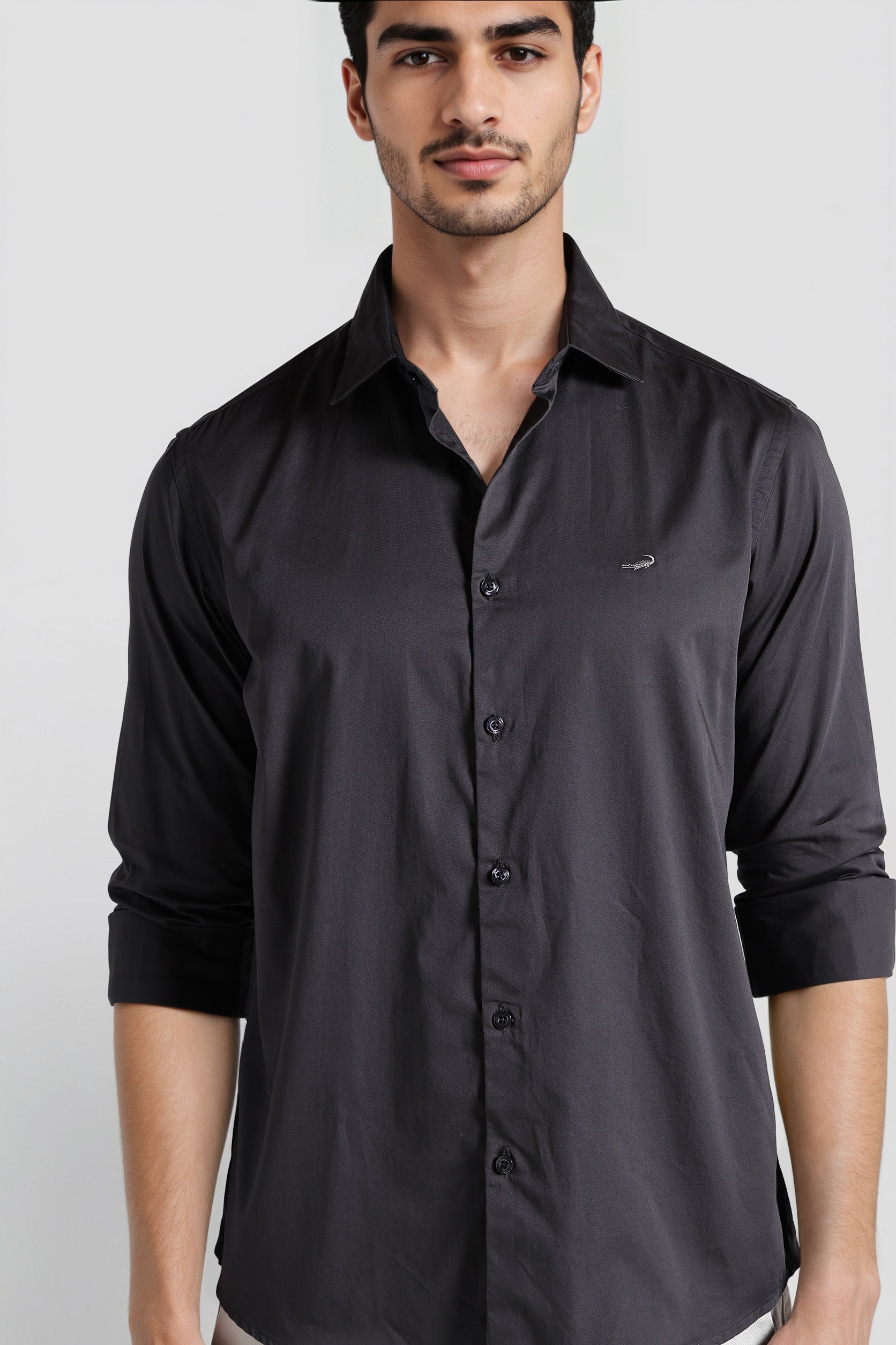 Man wearing a black shirt against a white background