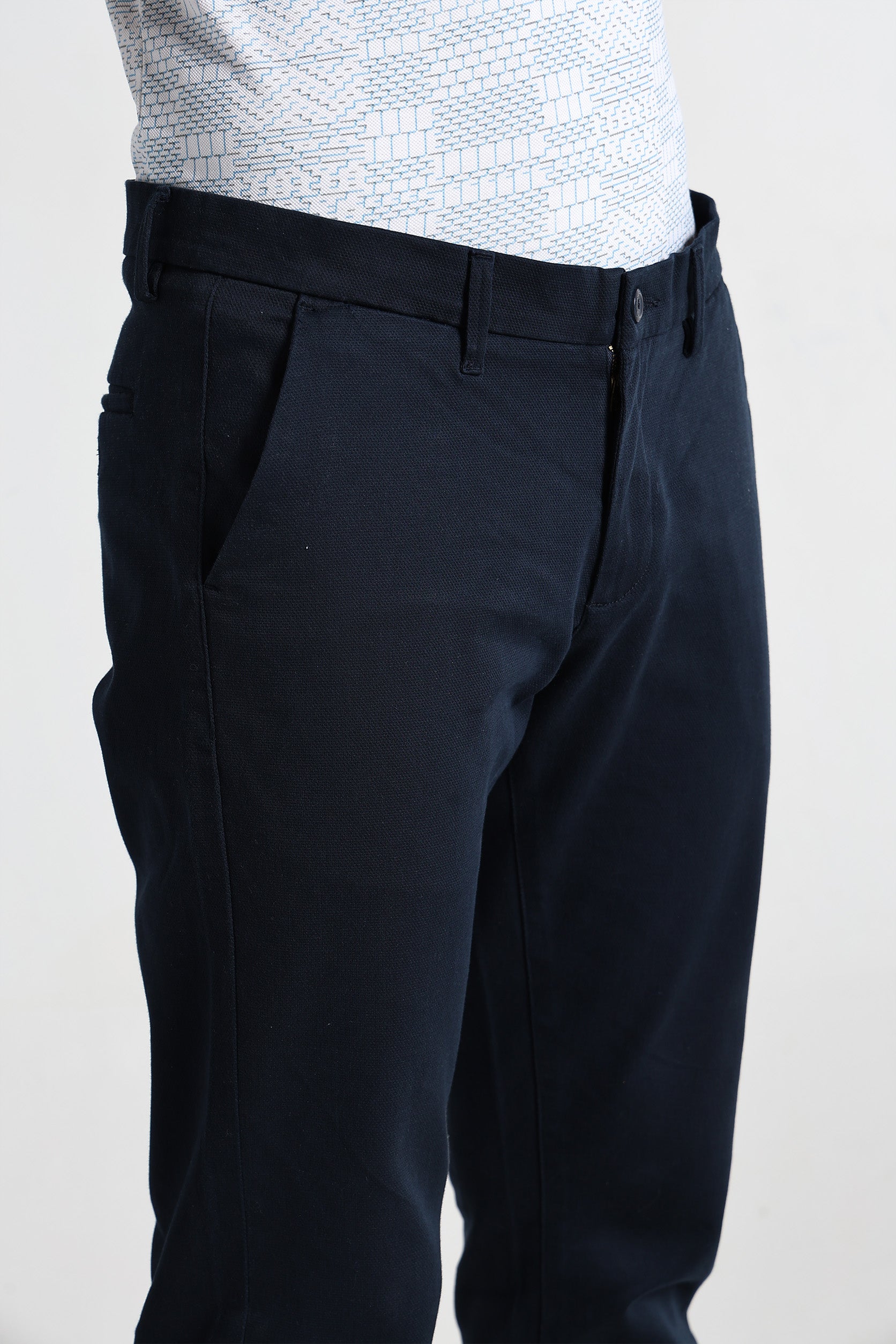 Black pants worn by a person on a white background