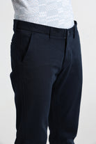 Black pants worn by a person on a white background