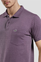 Purple checkered polo shirt with a brand logo on a light gray background