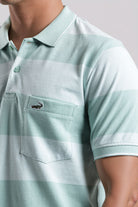 Light blue polo shirt with a brand logo on a neutral background