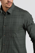 Green checkered shirt worn by a person on a light gray background